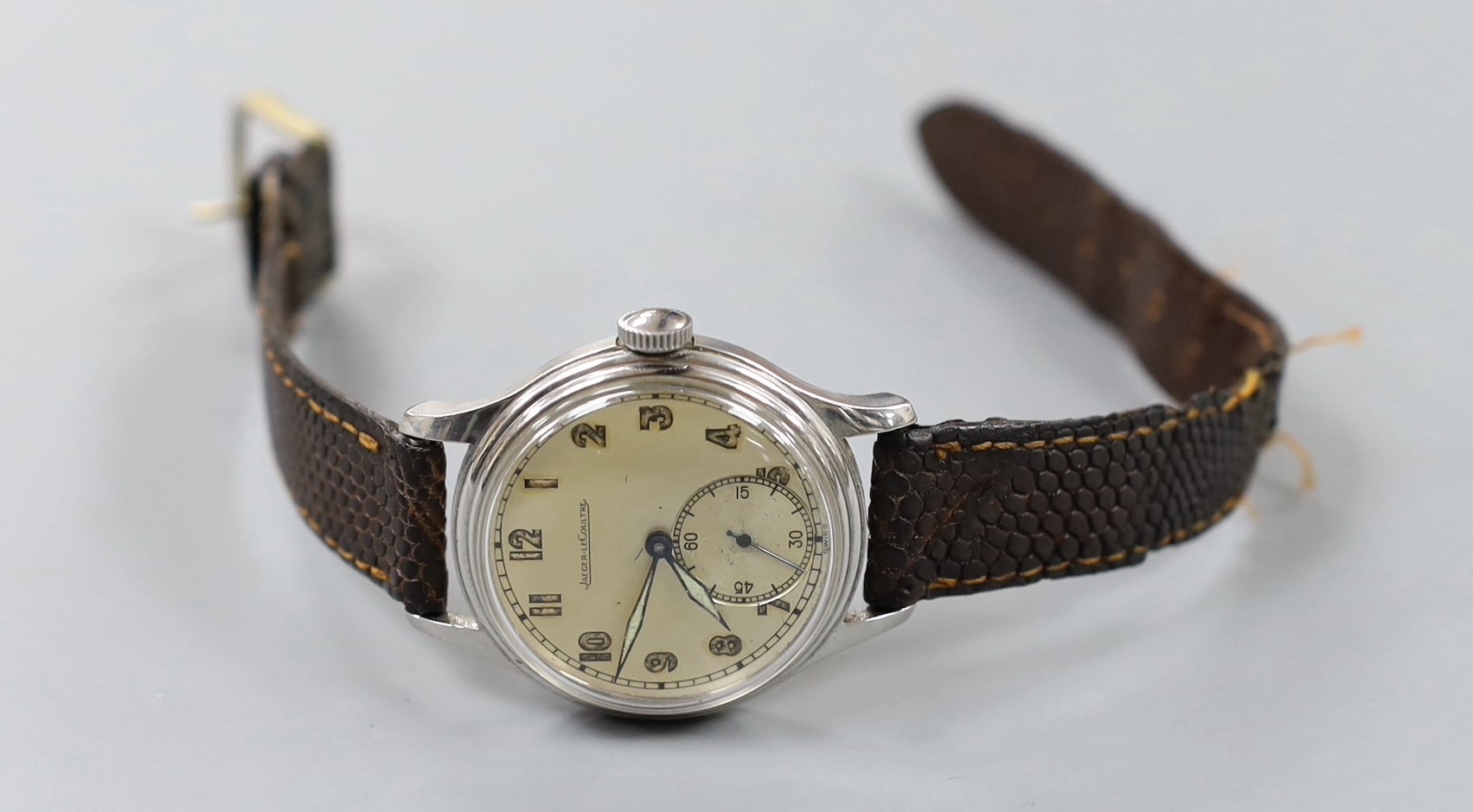 A gentleman's stainless steel Jaeger LeCoultre manual wind wrist watch, with Arabic dial and subsidiary seconds, on associated leather strap.